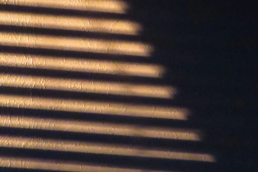 Ceiling with shadows from streetlight through blinds